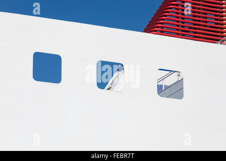 White outer wall and red chimney of a ship at the Baltic Sea against a blue sky Stock Photo