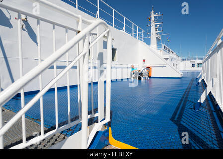 Male passenger sunbathing on the deck of ship on the Baltic Sea in summer on the trip from Germany to Sweden Stock Photo