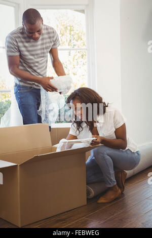 Ethnic couple unwrapping their stuff in boxes Stock Photo