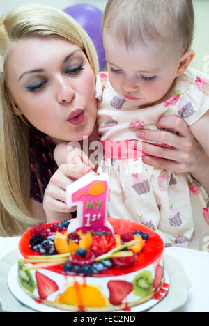 Mother celebrating baby's first birthday Stock Photo