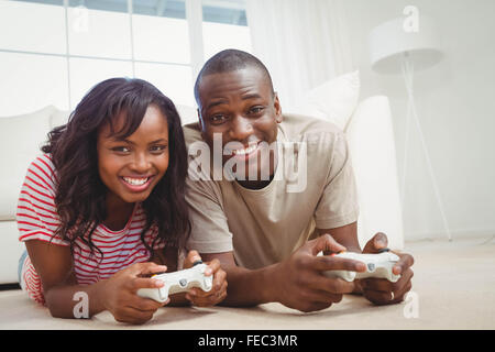 Ethnic couple playing video games Stock Photo