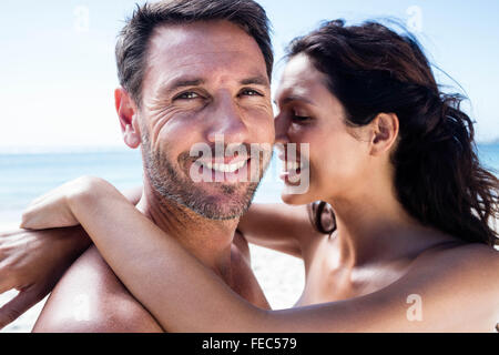 Cute couple cuddling with arms around Stock Photo