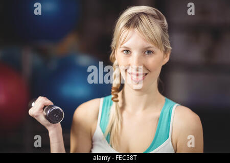 Blonde woman exercising with dumbbells Stock Photo