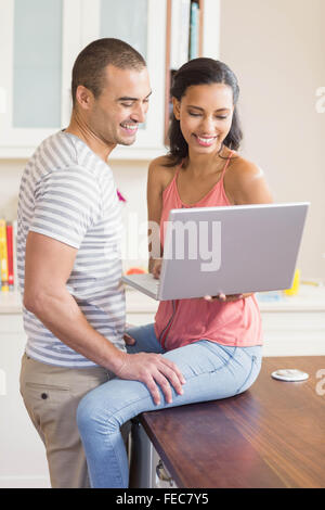 Smiling couple using laptop Stock Photo
