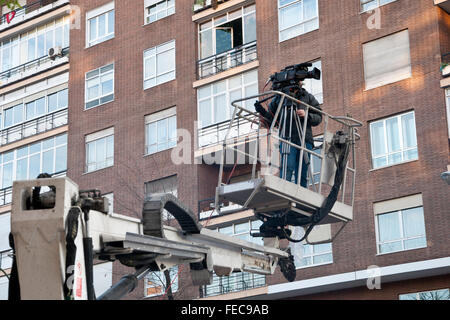 Cameraman working on an aerial work platform Stock Photo