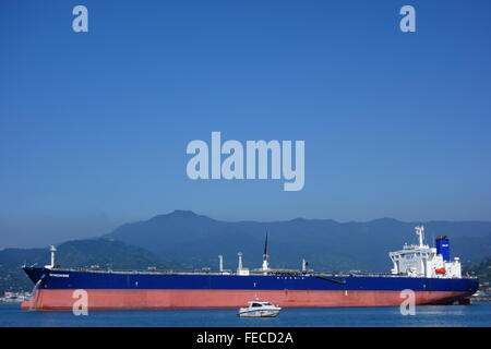 Oil tanker and a coast guard vessel in Batumi oil terminal on a sunny summer day. Stock Photo