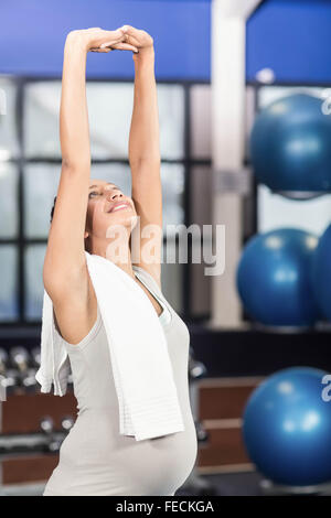 Pregnant woman doing stretching exercises Stock Photo