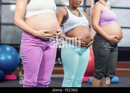 Pregnant women touching bellies Stock Photo - Alamy