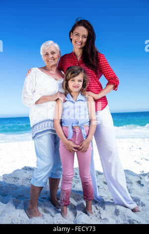 Multi generation family standing and smiling Stock Photo