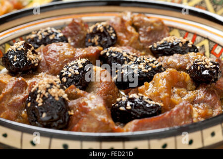 Moroccan dish with meat, plums and sesame seeds close up Stock Photo