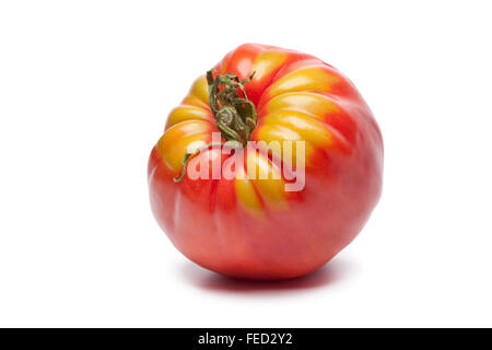 Fresh single Coeur de Boeuf tomato on white background Stock Photo