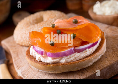 A delicious homemade toasted sesame seed bagel with smoked salmon, whipped cream cheese, red onion, and capers.