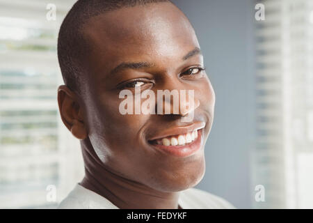 Smiling man looking through the window Stock Photo