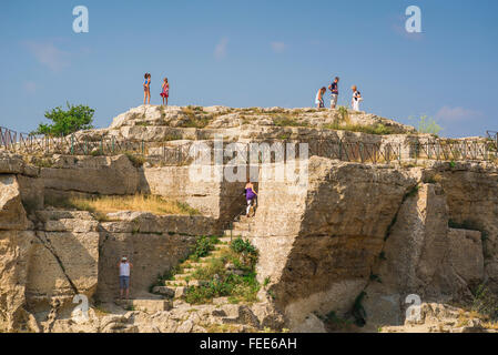 Rocca di Cerere, view of tourists walking on top of the Rocca di Cerere, a ruined ancient shrine on the easternmost point of the city of Enna, Sicily. Stock Photo