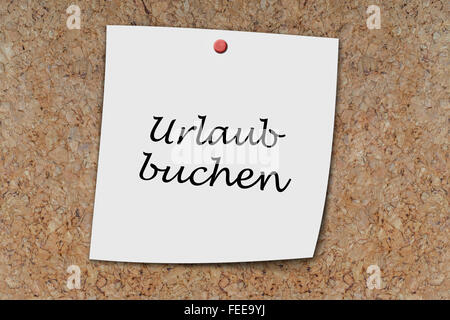 urlaub buchen (german book vavation) written on a memo pinned on a cork board Stock Photo