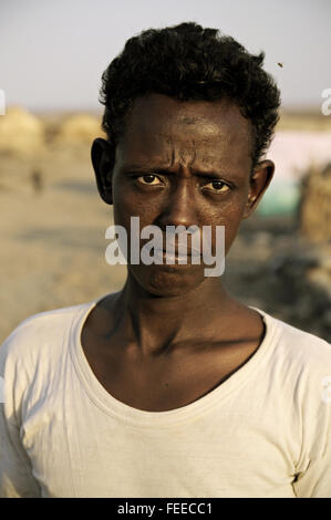 Head portrait of a man with a white t-shirt in the village of Ahmed Ela, Danakil depression, Afar Region, Ethiopia Stock Photo