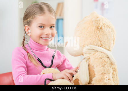 Little girl playing with stethoscope Stock Photo