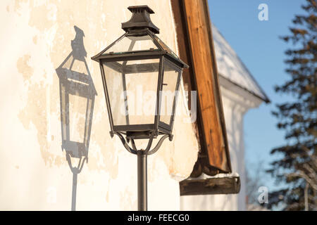 Old Street Light with its shadow on a wall Stock Photo