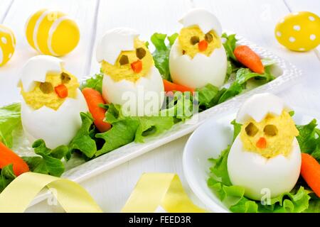Fun Easter breakfast of hatching chicks made of boiled eggs Stock Photo