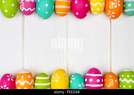 Colorful Easter egg frame against a white wood background Stock Photo