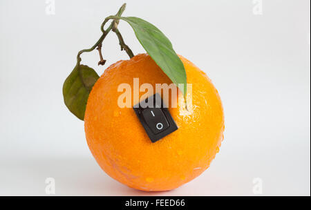 Single orange with switch in power off position on light grey background Stock Photo