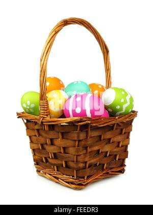 Easter basket filled with colorful eggs on a white background Stock Photo