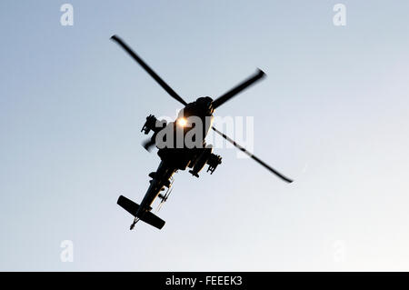 AgustaWestland Apache attack helicopter flying on a training mission over Woodbridge airfield, Suffolk, UK. Stock Photo