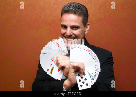 Magician make performance with card deck Stock Photo