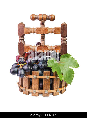 grapes in a wooden vase in the form of press isolated on white Stock Photo