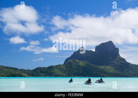 People on jetskis, Bora Bora, Society Islands, French Polynesia Stock Photo