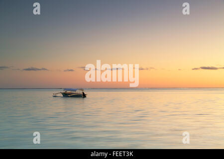 Boat at sunset, Bora Bora, Society Islands, French Polynesia Stock Photo