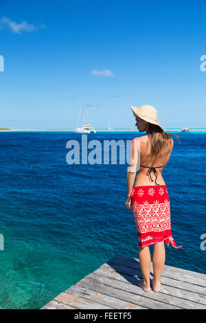 Woman standing on jetty, Tetamanu, Fakarava, Tuamotu Islands, French Polynesia = Stock Photo