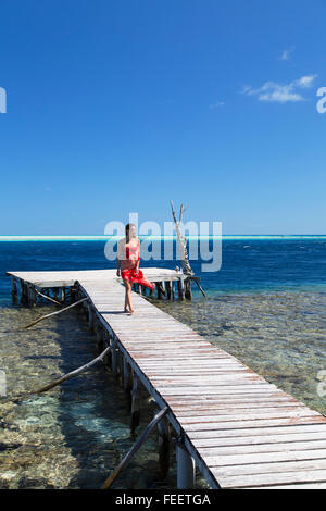 Woman walking on jetty, Tetamanu, Fakarava, Tuamotu Islands, French Polynesia Stock Photo