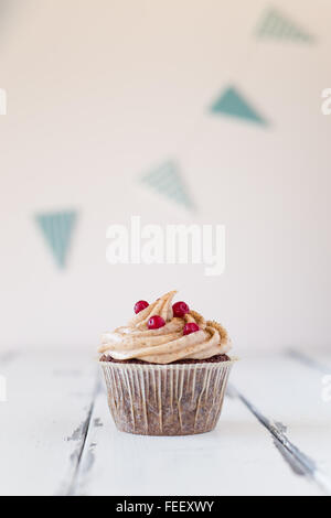 birthday cupcake with red currants and frosting Stock Photo