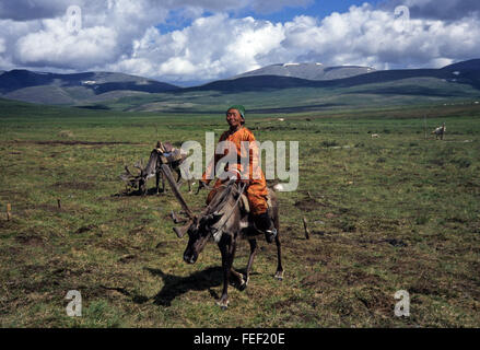 Duhkha (same as Tsaatan) woman riding her reindeer Stock Photo