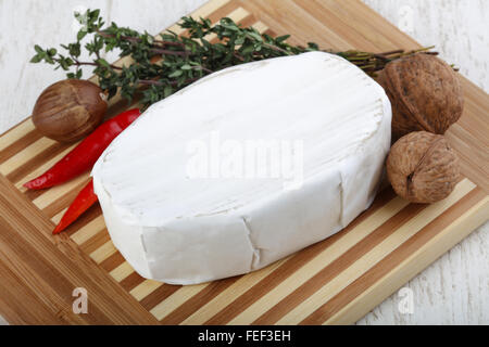 Brie cheese with thyme leaves and nuts Stock Photo