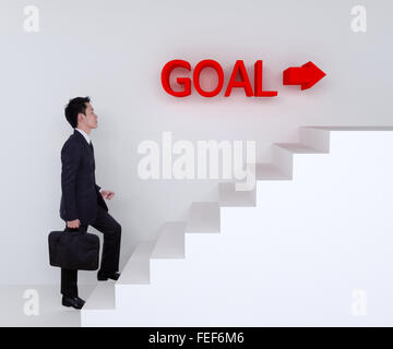 Business man stepping up on stairs to goal Stock Photo