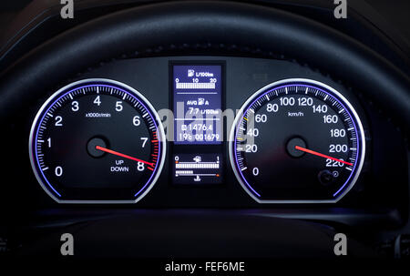 Illuminated car dashboard displaying maximum speed.