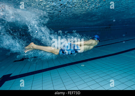 Young man swimming in pool Stock Photo