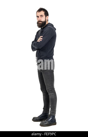 Confident serious punker wearing old boots and black hooded sweatshirt looking at camera. Full body portrait isolated on white Stock Photo