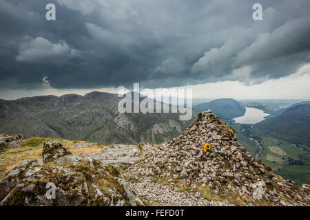 Looking across to the Scafell pike mountain range from the westmorland memorial cairn on great gable. Stock Photo