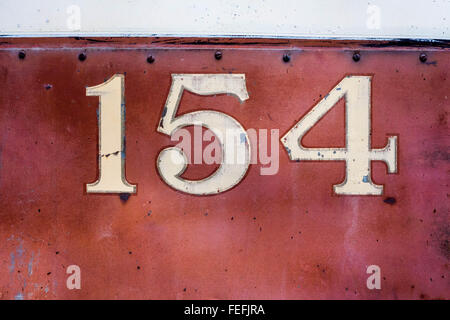 #154 painted on the side of an abandoned Brill Trolley bus, that is beyond the need for repair, good for textures, fade paint Stock Photo
