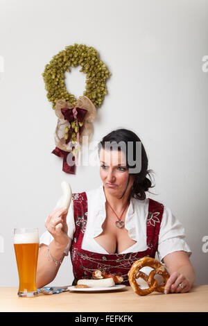 bavarian woman in a dirndl with sausages Stock Photo