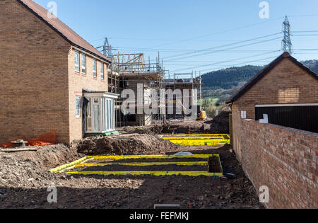 New build houses on estate with foundations being laid, Llanfoist, Wales, UK Stock Photo