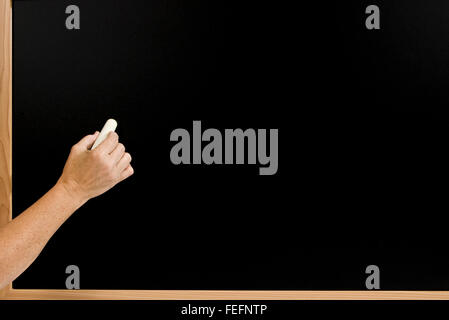 Hand Ready To Write On Blank Chalk Board Stock Photo