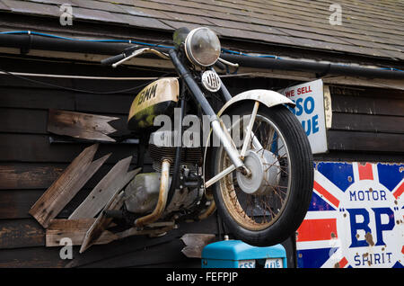 Vintage motorbike mounted on the exterior wall of Battlesbridge Motorcycle Museum in Essex, UK Stock Photo