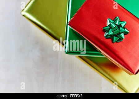 Boxes of gifts with a bow, on  wooden table in different colors Stock Photo
