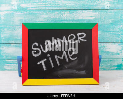 Blackboard with text it's summer time on wooden deck Stock Photo