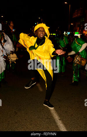 Madrid, Spain 6th February 2016. A female dancer from Senegal wearing a yellow costume. The carnival parade in Madrid, Gran Pasacalles del Carnaval (The Grand Carnival Parade), was held in the district of Tetuán Madrid, Spain.  Credit:  Lawrence JC Baron/Alamy Live News. Stock Photo