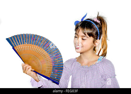 Beautiful little girl holding a fan Stock Photo